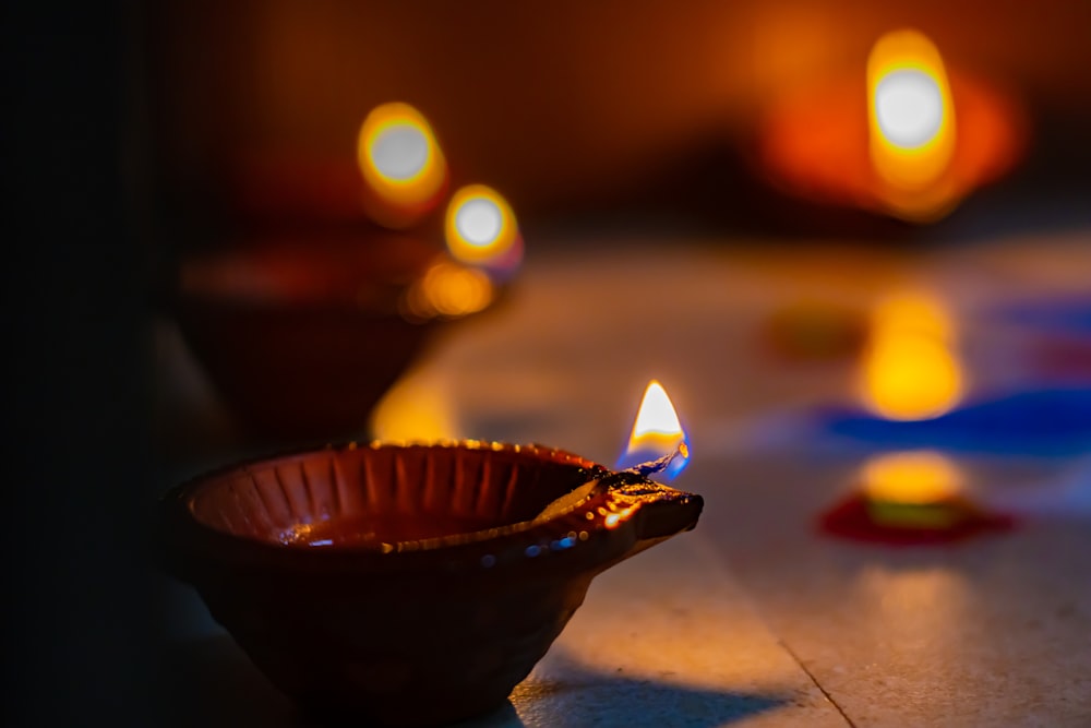 a lit candle sitting on top of a wooden table