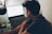 a man sitting in front of a laptop computer