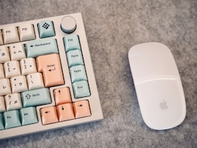 a computer keyboard and mouse on a table