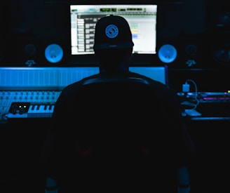 a man sitting in front of a mixing desk