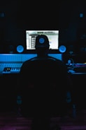 a man sitting in front of a mixing desk