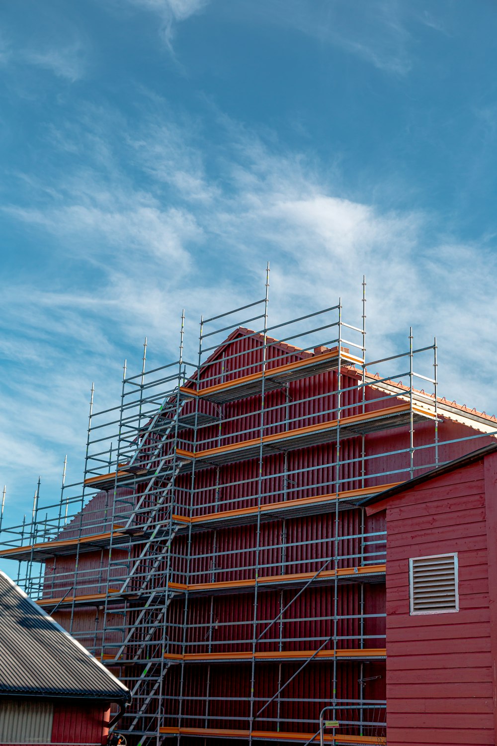 a red building with scaffolding around it