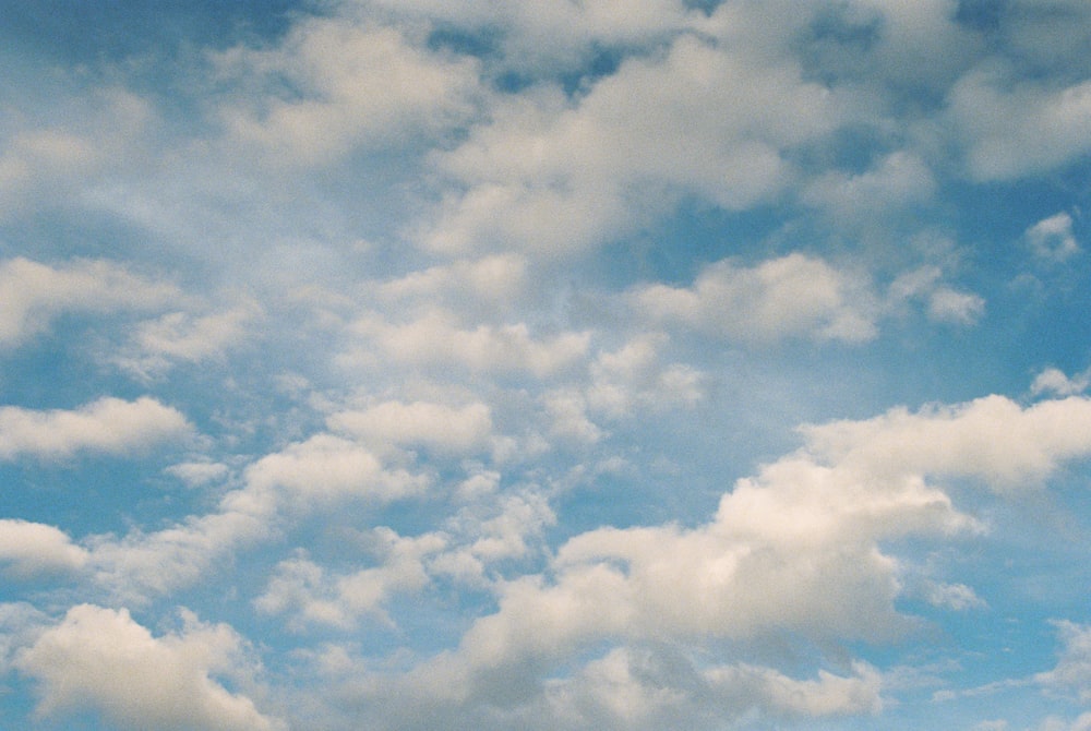 a plane flying in the sky with a lot of clouds