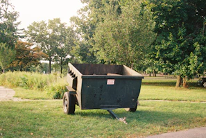 a dumpster sitting in the middle of a park