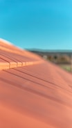 Close-up of a freshly tiled roof with red clay tiles under a clear blue sky