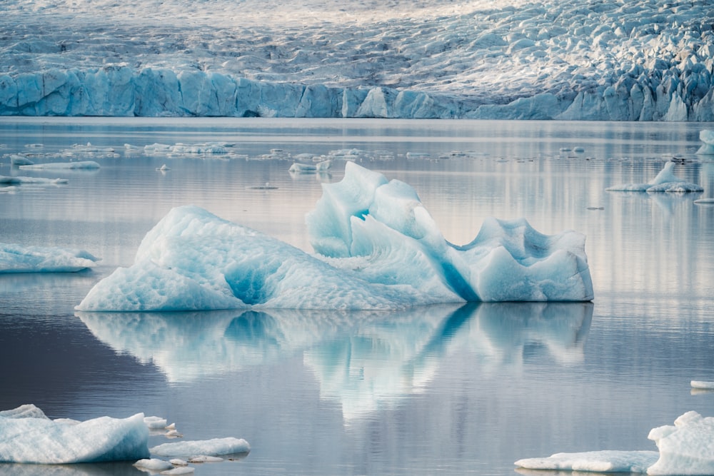 a large iceberg floating on top of a body of water