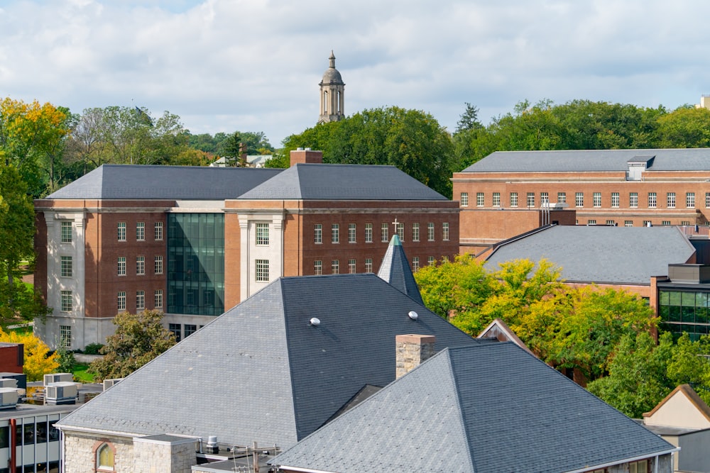 a group of buildings with a clock tower in the background