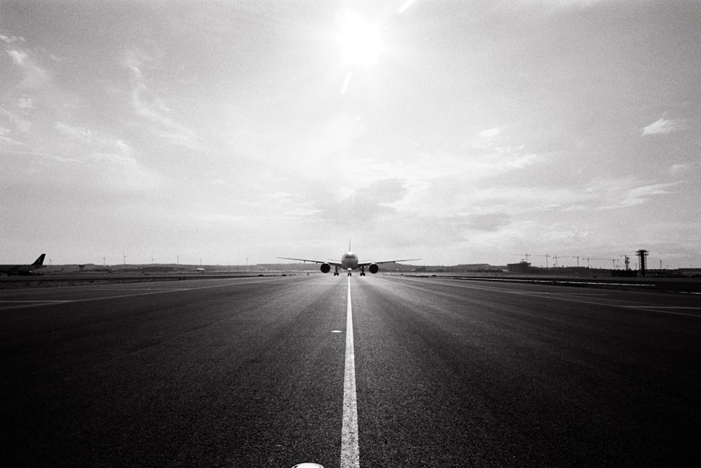 a black and white photo of an airport runway