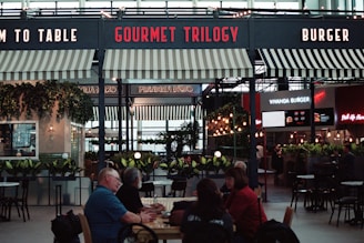 a group of people sitting at a table in a restaurant