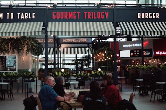 a group of people sitting at a table in a restaurant