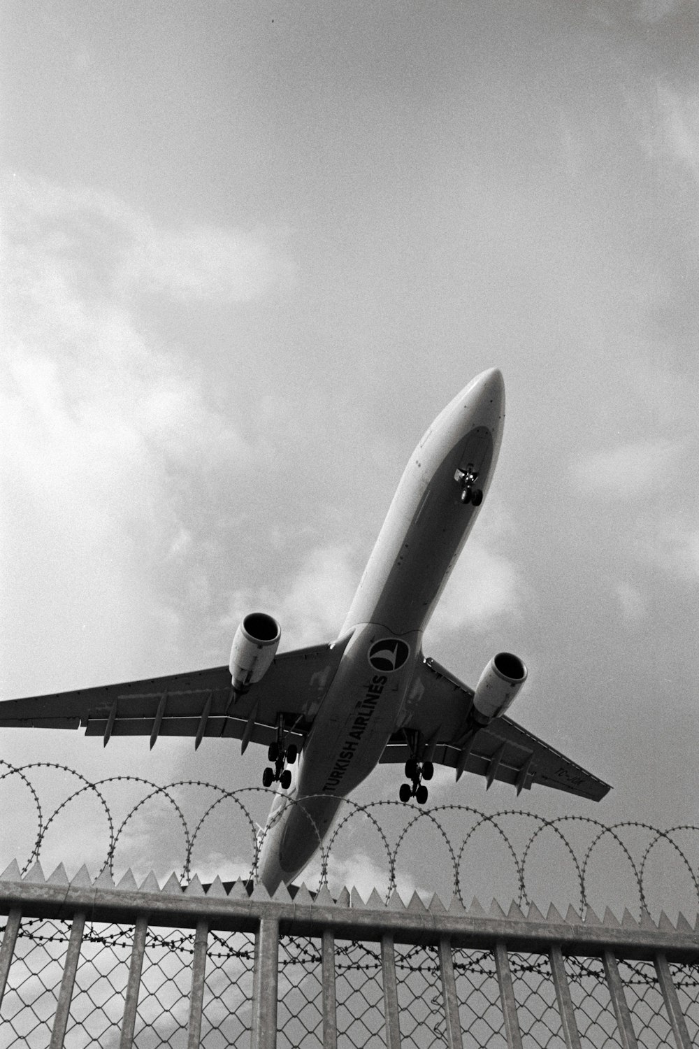 a large jetliner flying through a cloudy sky