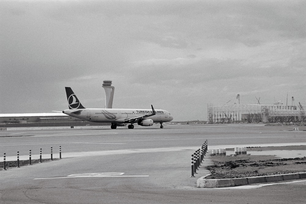 a large jetliner sitting on top of an airport tarmac