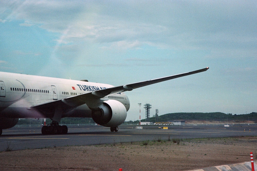 a large jetliner sitting on top of an airport tarmac