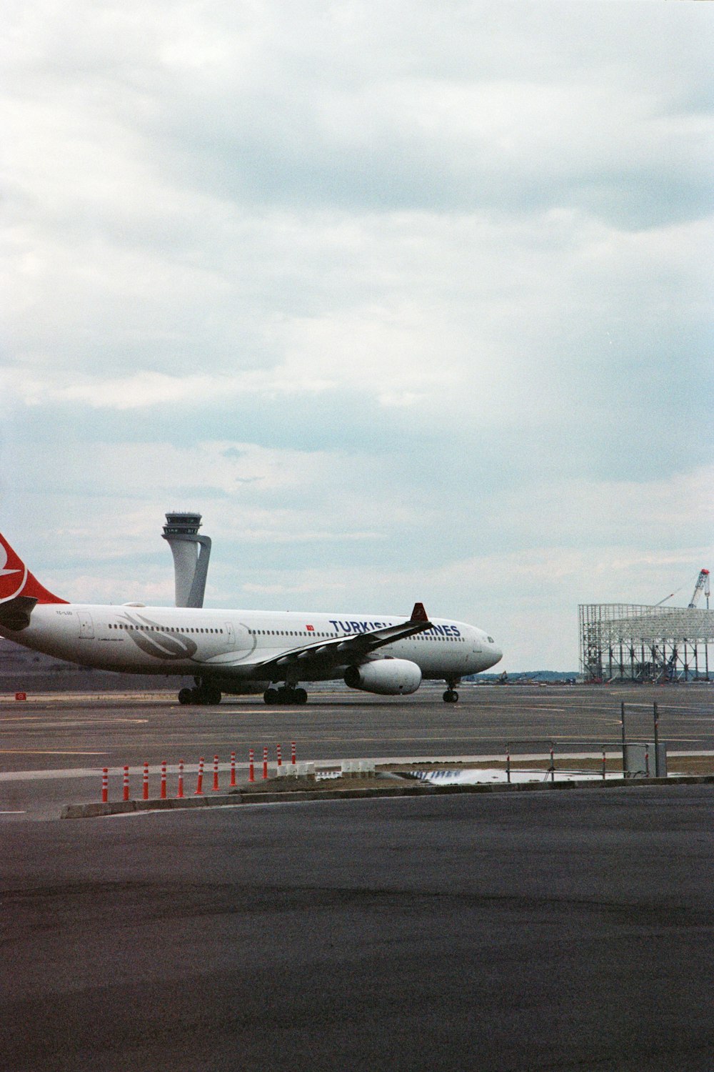 a large jetliner sitting on top of an airport tarmac