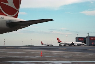 a number of airplanes on a run way