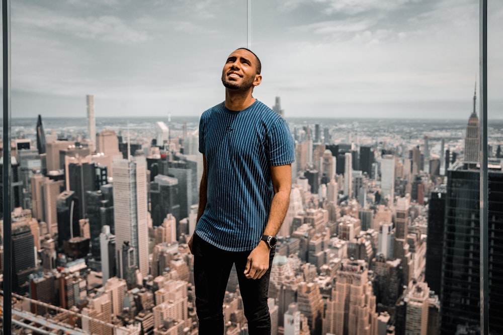 a man standing on top of a tall building