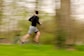 a blurry photo of a man running in a park