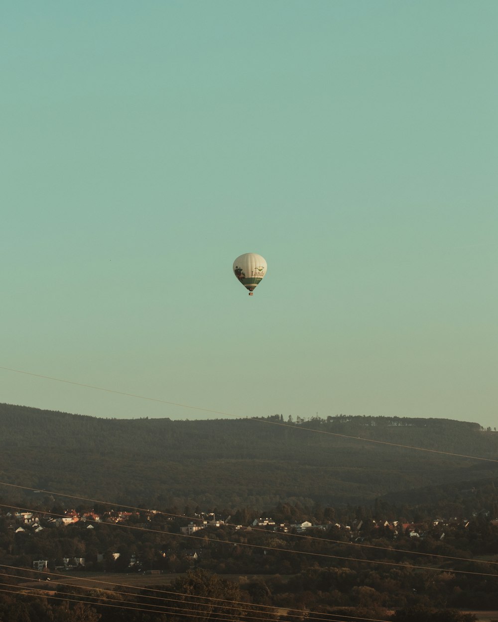 a hot air balloon flying over a city