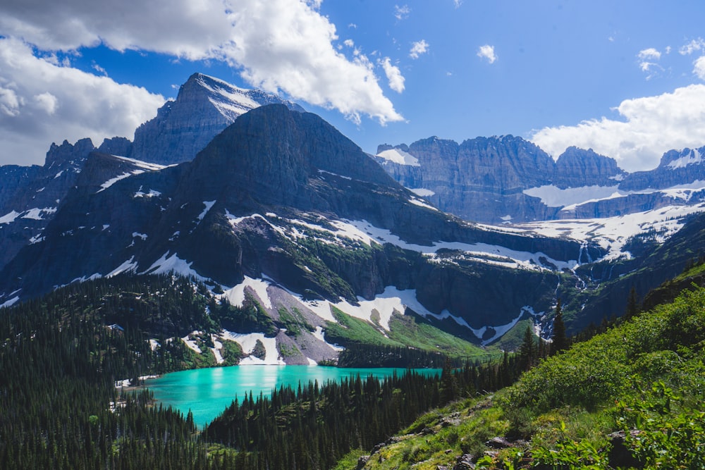 a view of a mountain range with a lake in the foreground