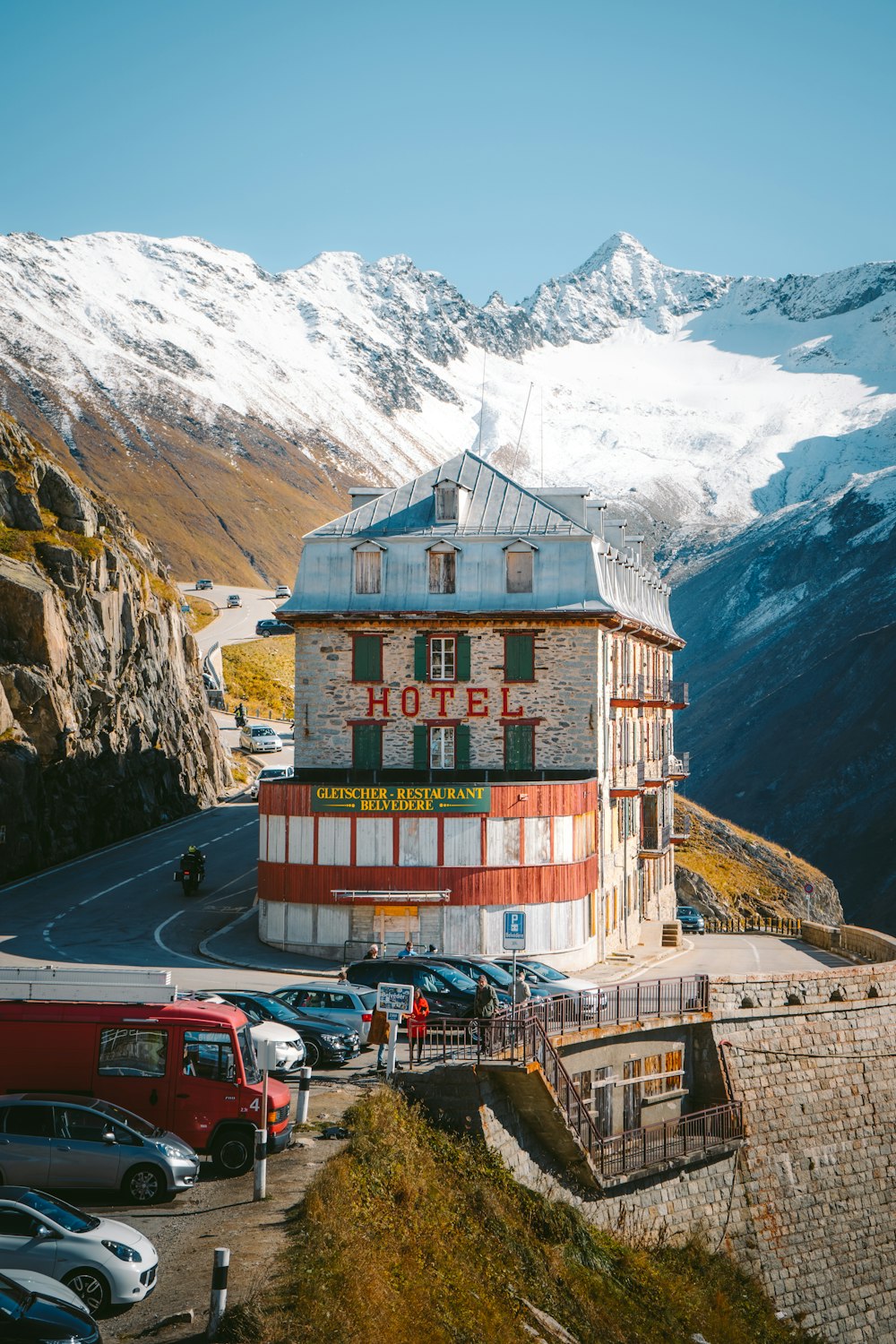 a hotel with a mountain in the background