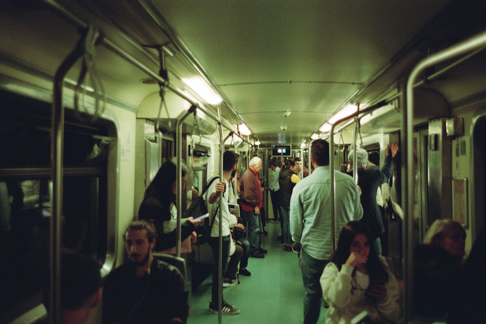 a group of people riding on a subway train