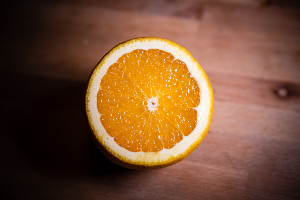 an orange cut in half sitting on a table