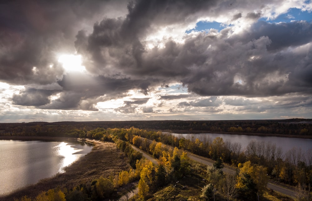 the sun shines through the clouds over a river