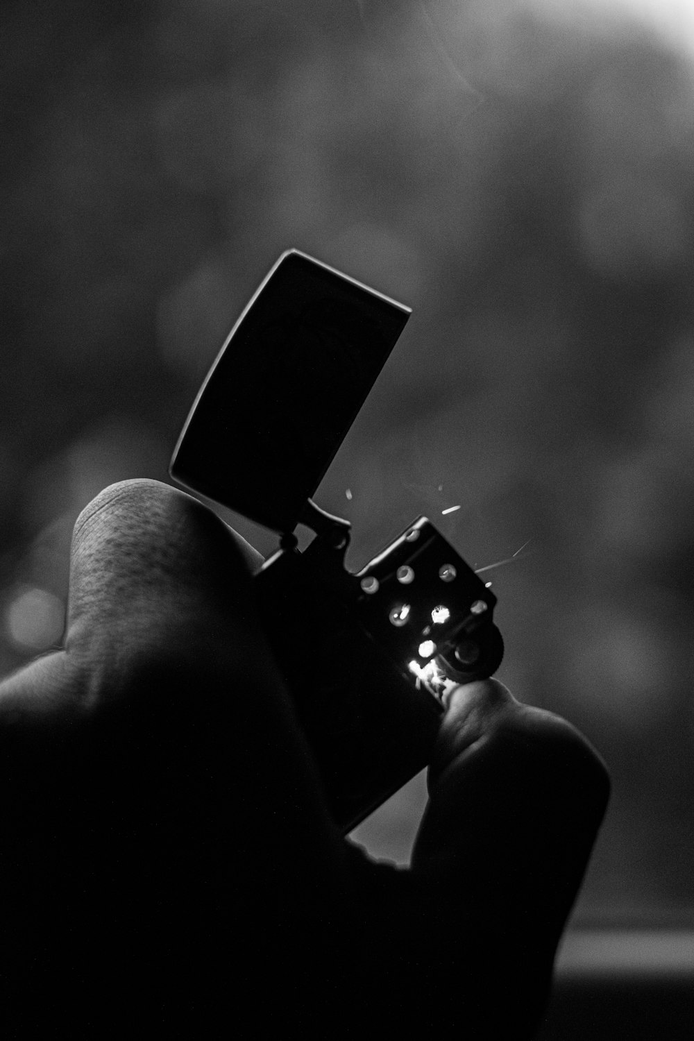 a black and white photo of a person holding a dice