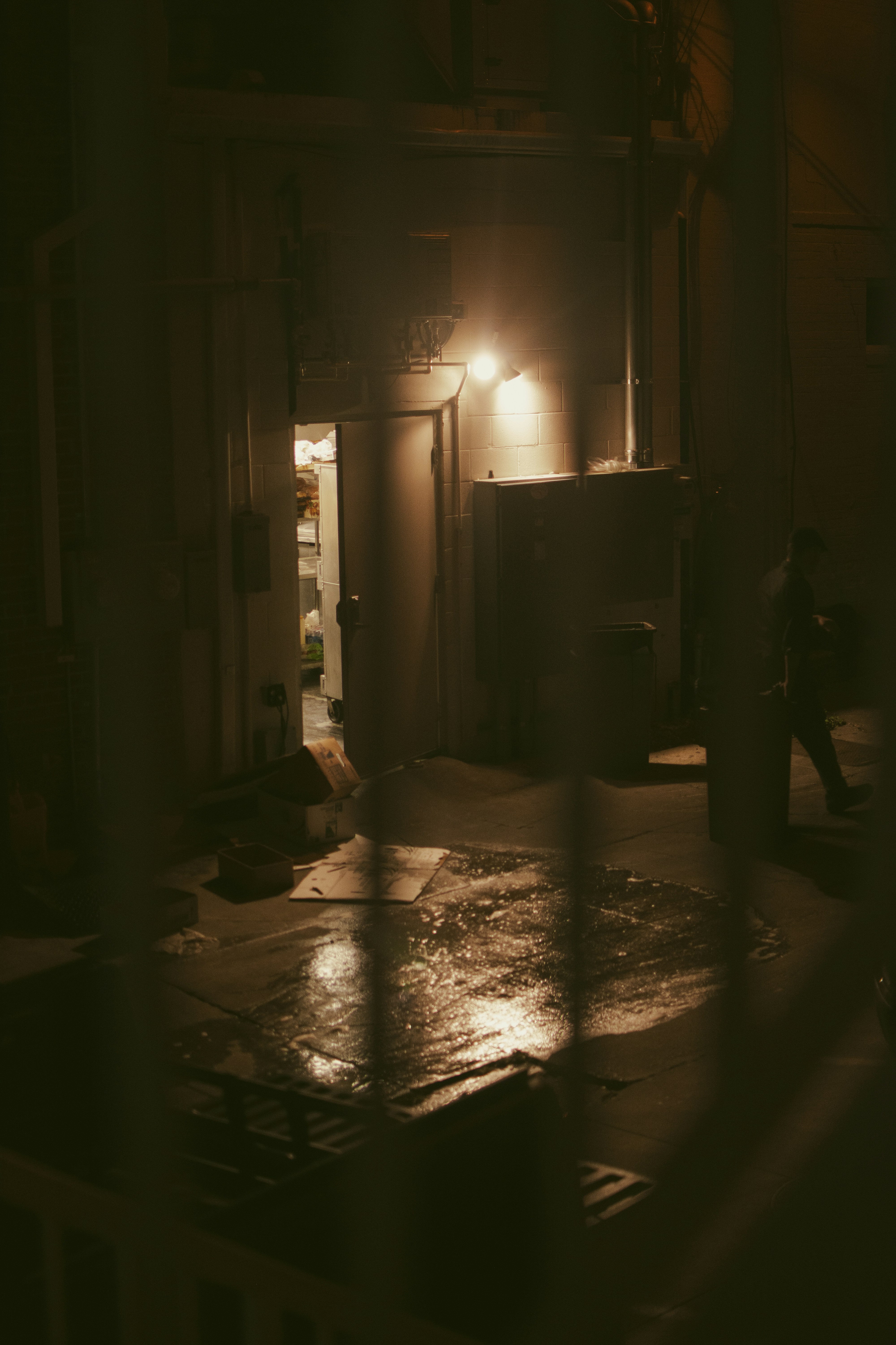 a person walking down a street at night