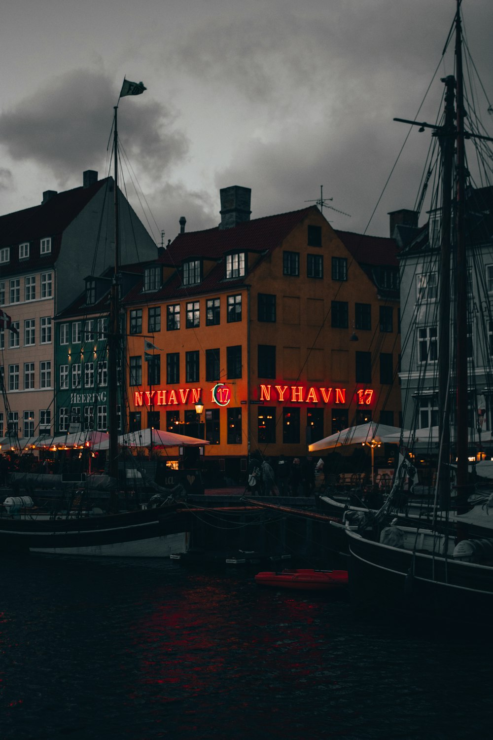 a harbor filled with lots of boats next to tall buildings