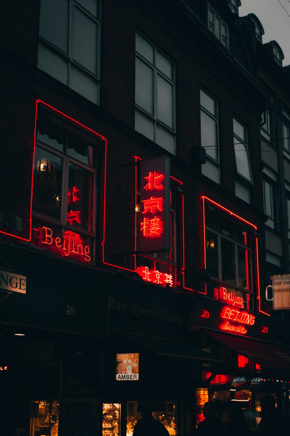 a red neon sign on the side of a building