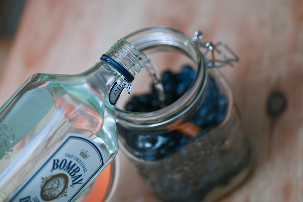 a bottle of blueberries sitting on top of a wooden table
