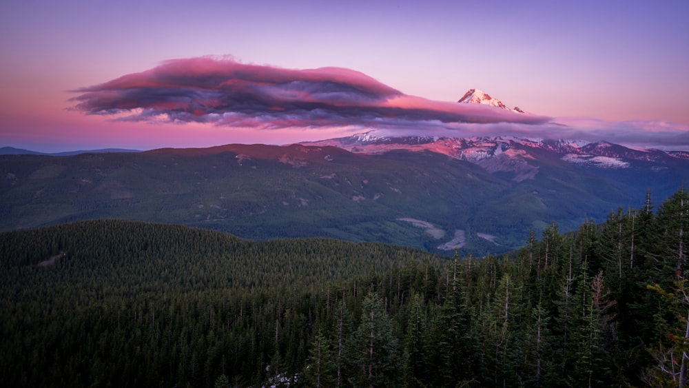 a view of a mountain range with a cloud in the sky