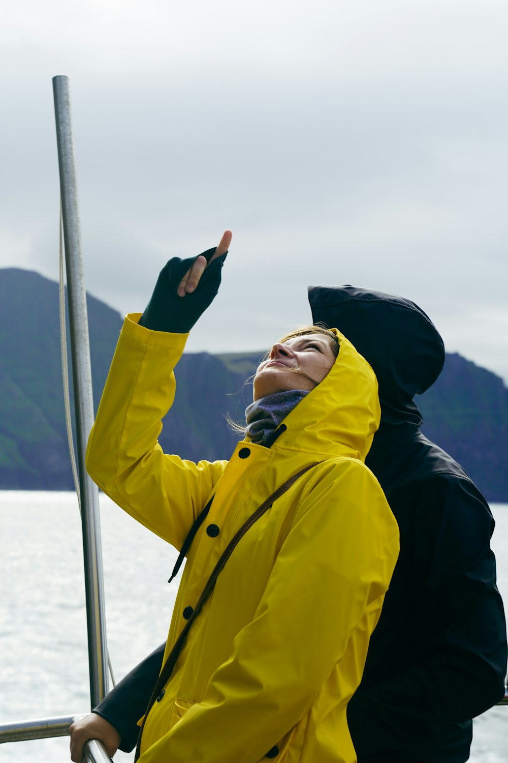 a woman in a yellow jacket on a boat