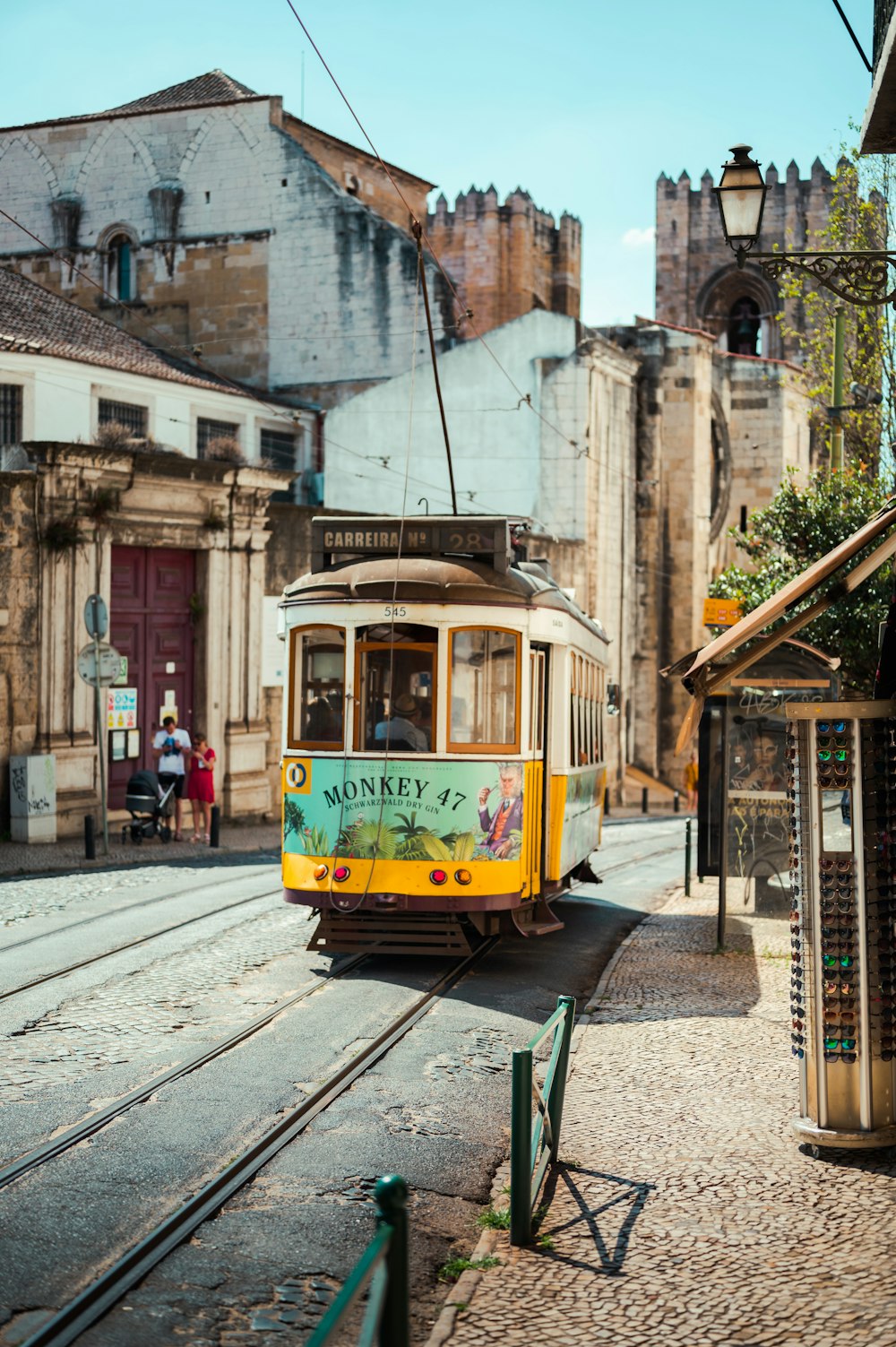 a trolley car traveling down a street next to tall buildings