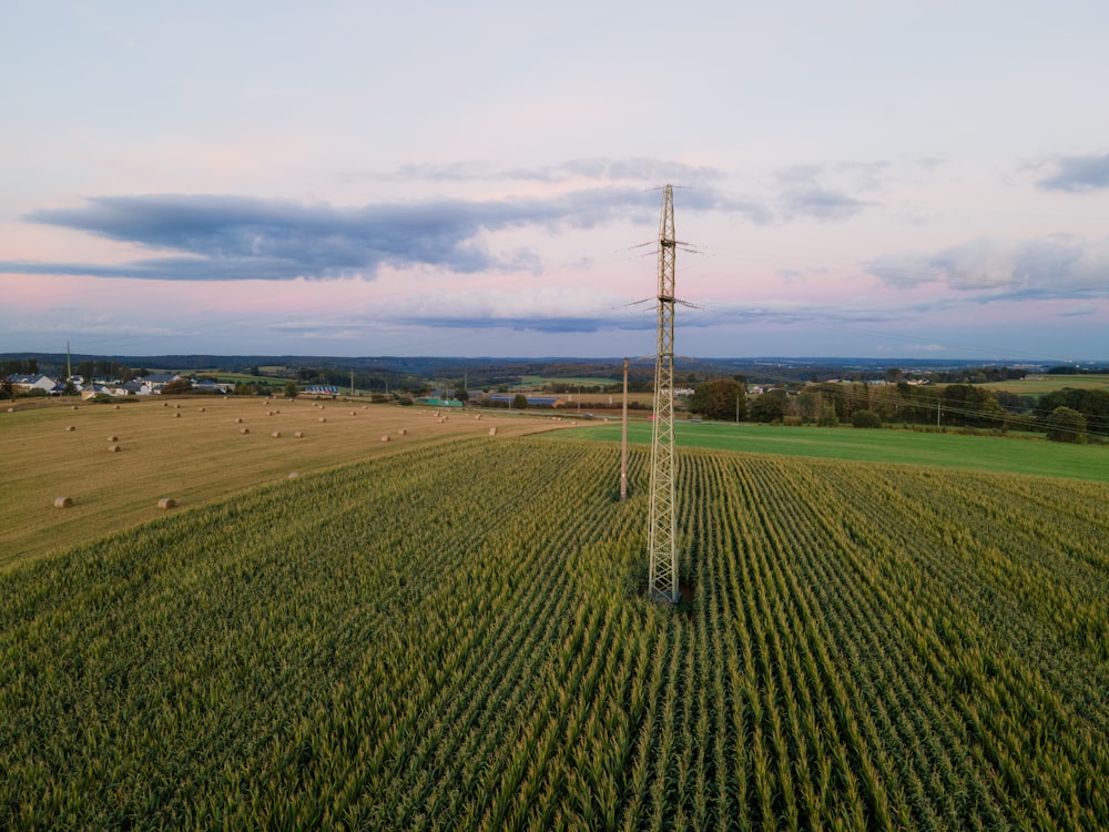 an aerial view of a field with a cell phone tower