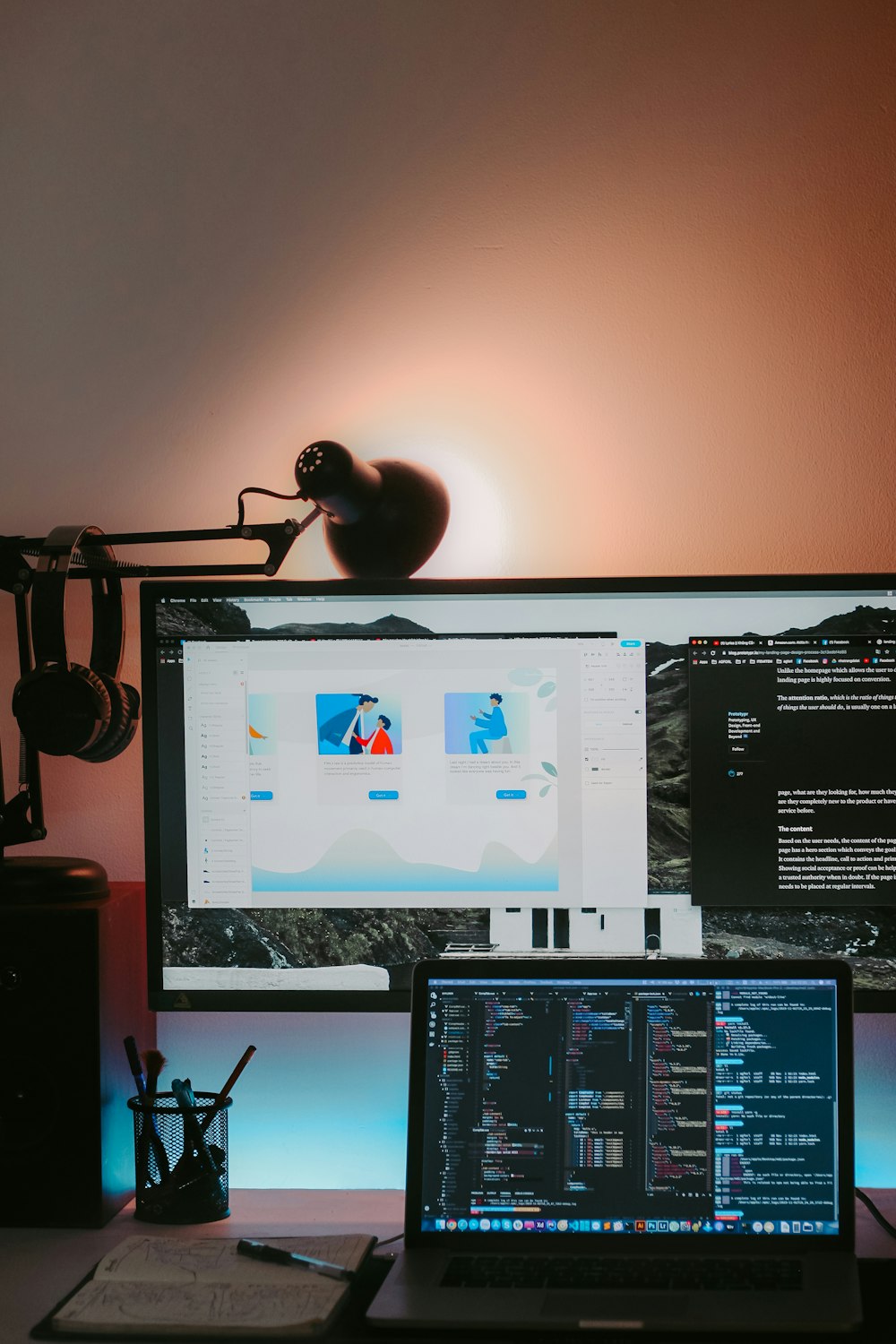 a desk with a laptop and a computer monitor