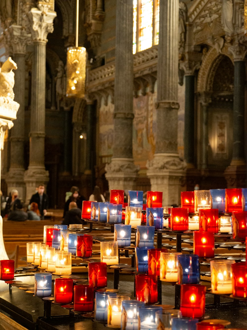 a church filled with lots of lit candles