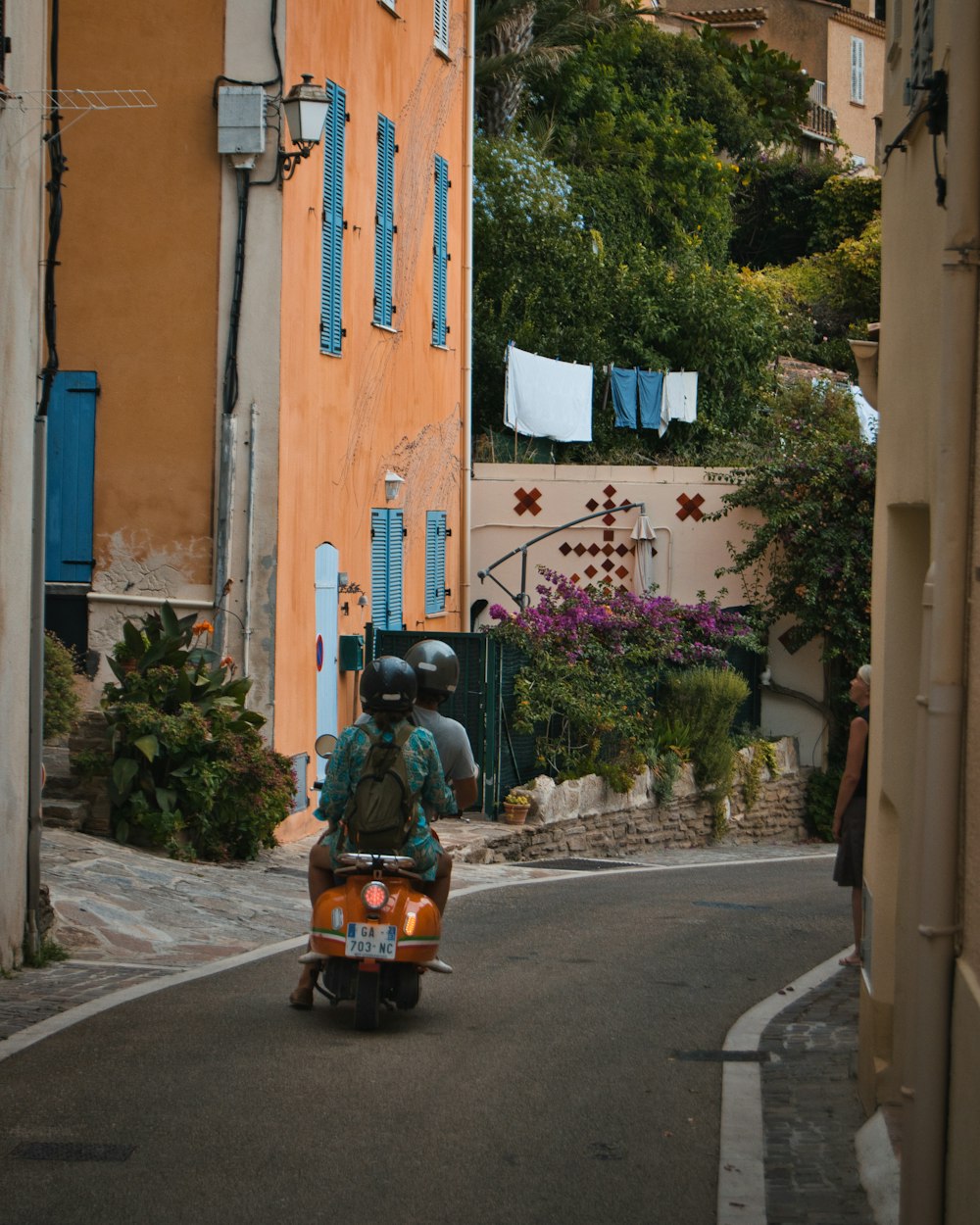 a person riding a motorcycle down a street