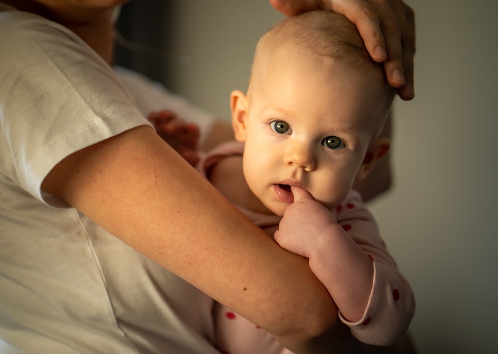 a woman holding a baby in her arms