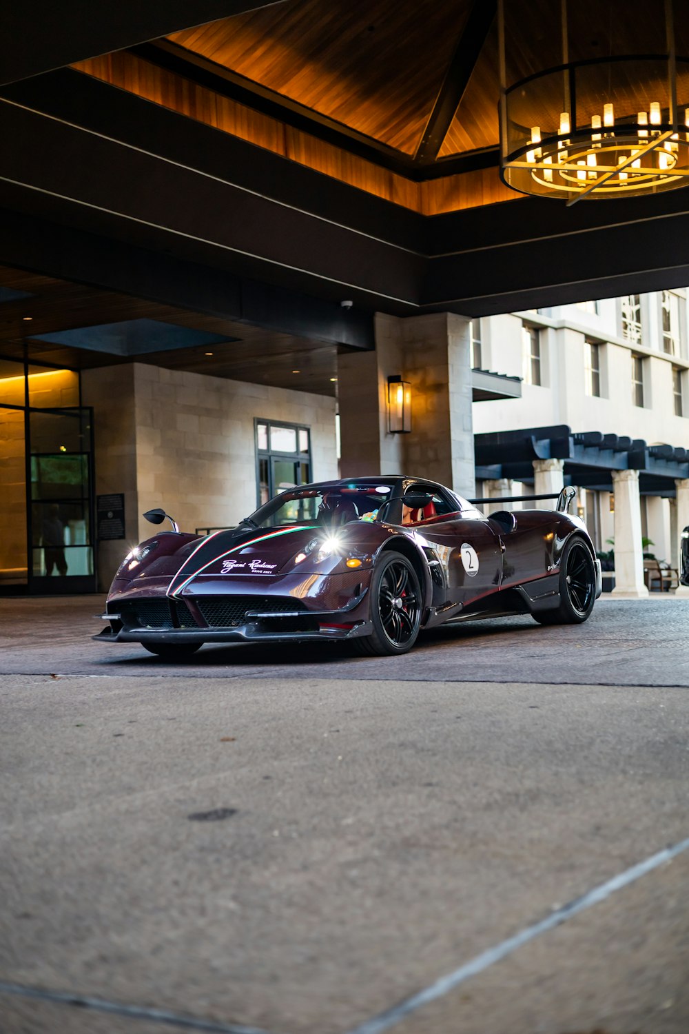 a sports car parked in front of a hotel