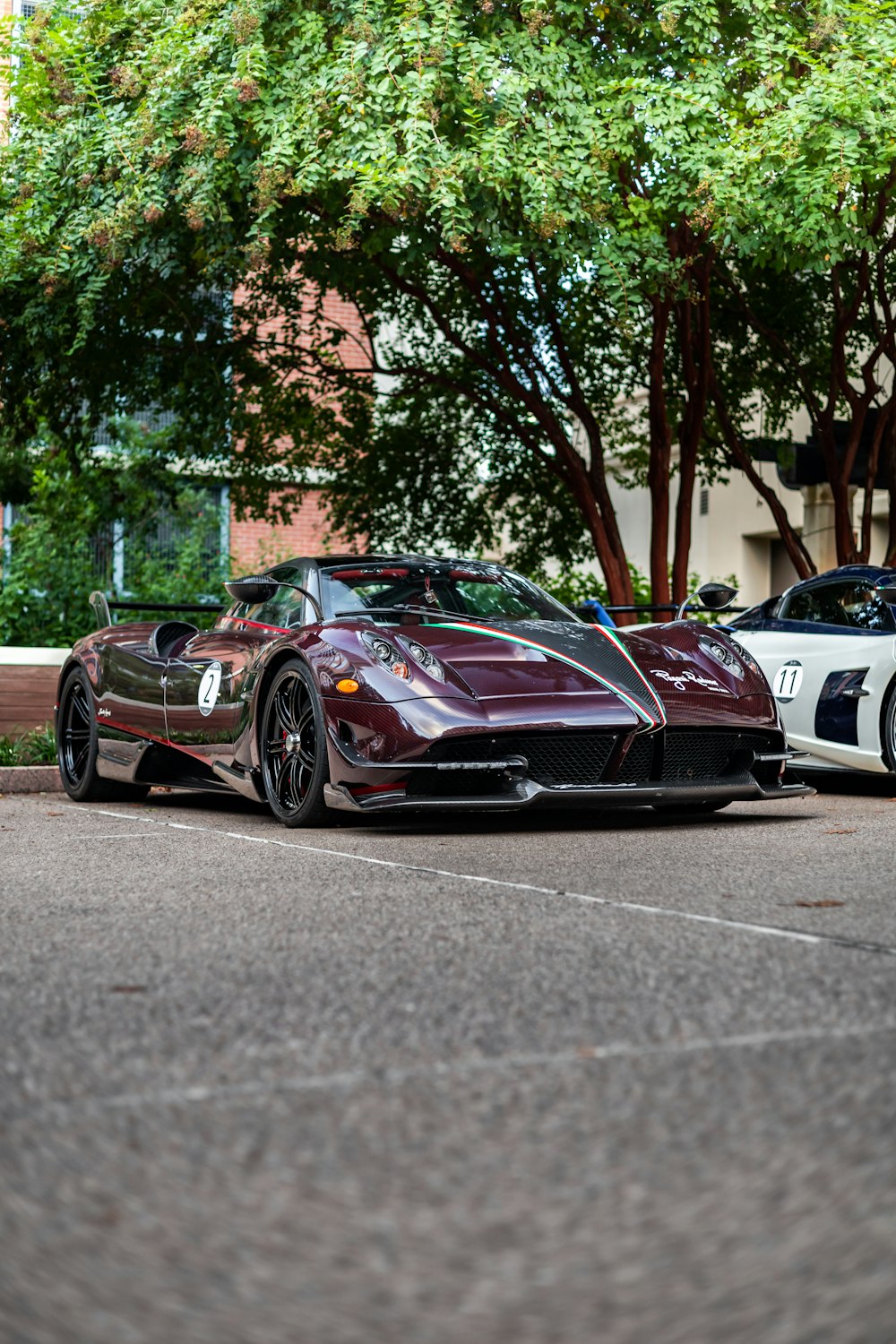 two exotic sports cars parked in a parking lot