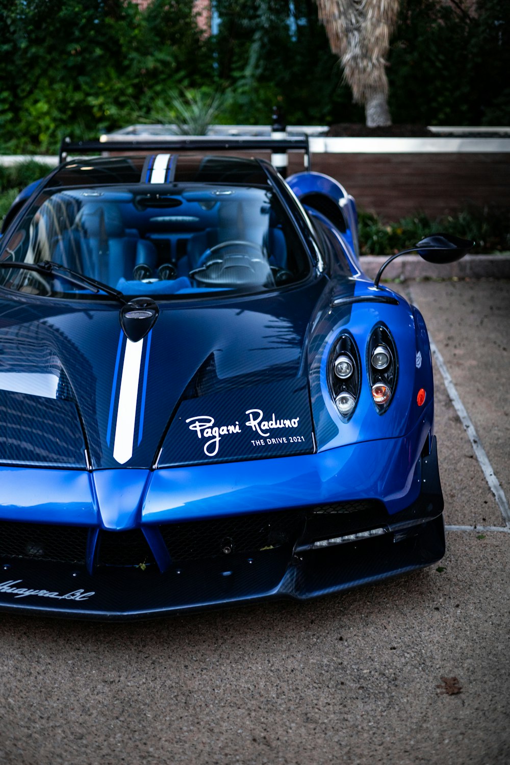 a blue sports car parked in a parking lot