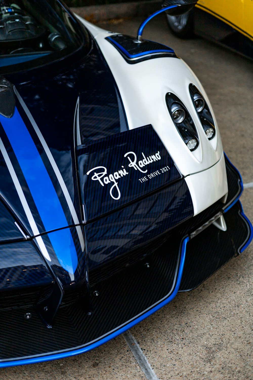 a close up of a blue and white sports car