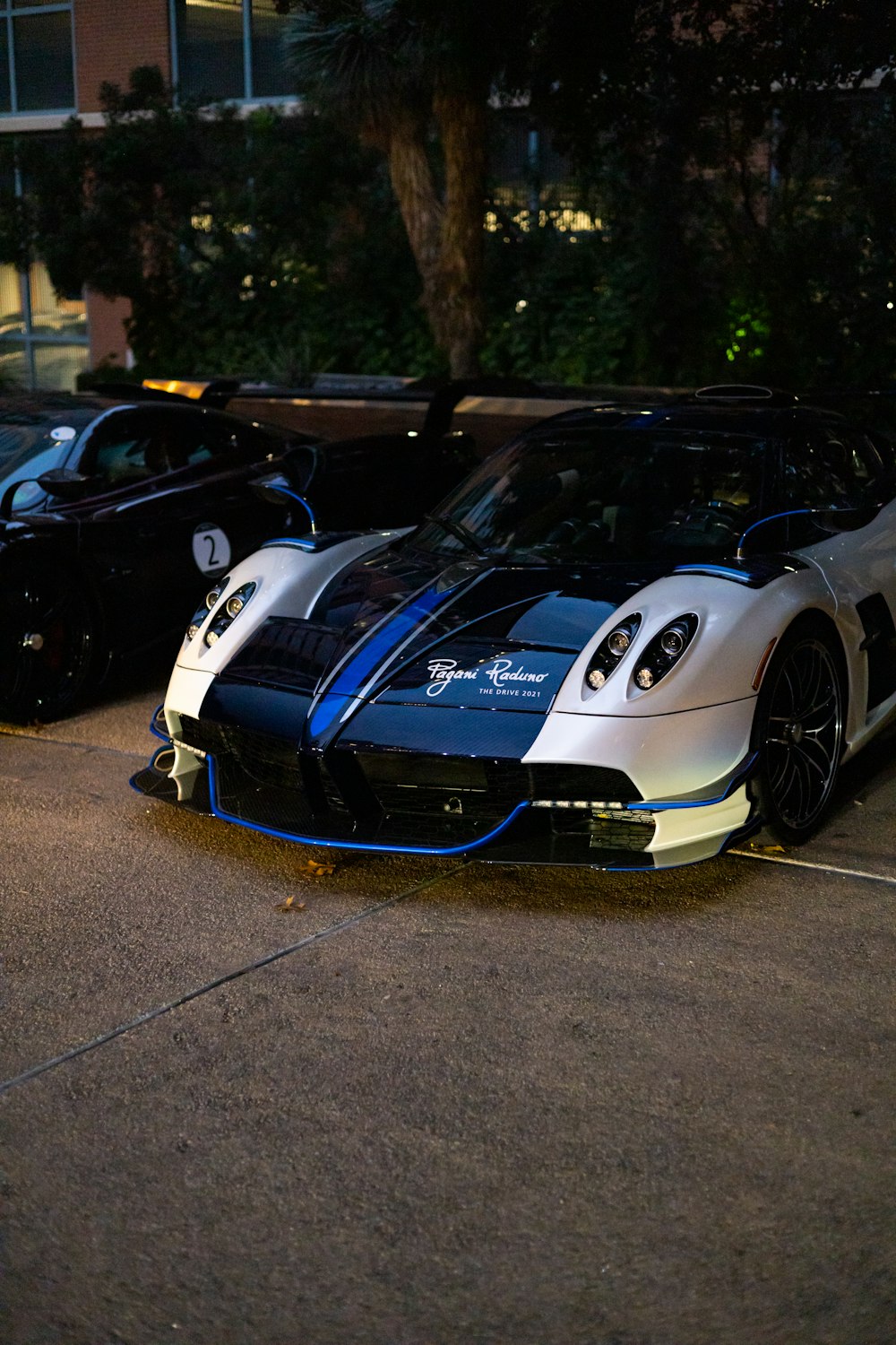 a couple of cars parked next to each other in a parking lot