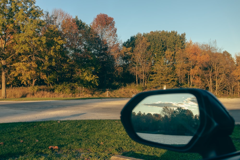 a rear view mirror of a car on the side of the road