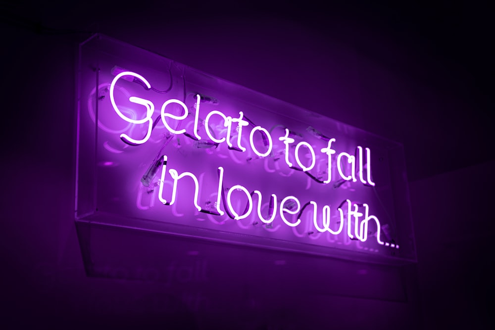 a purple neon sign that says gelato fall in love with