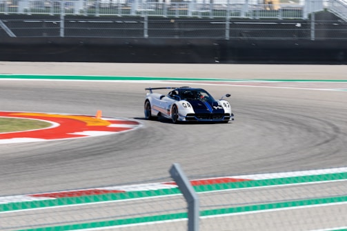 High-speed racing car navigating a sharp turn on a track.