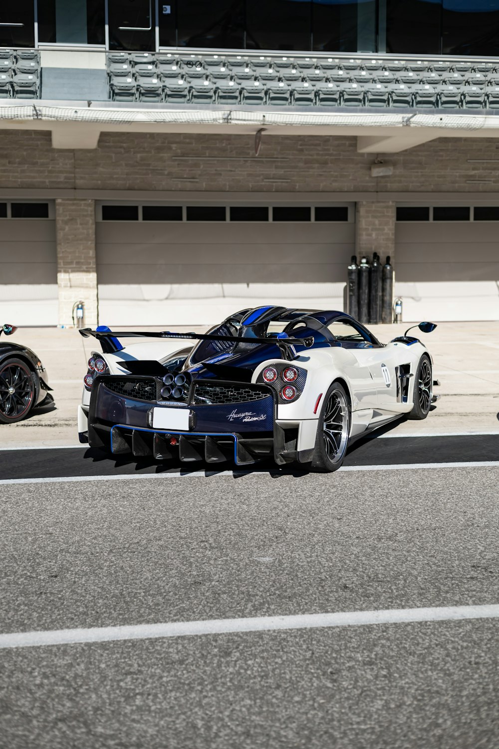 two racing cars parked in front of a building
