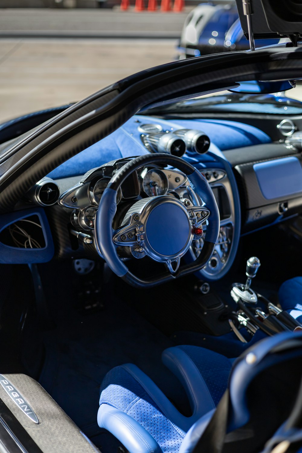 the interior of a sports car with blue leather